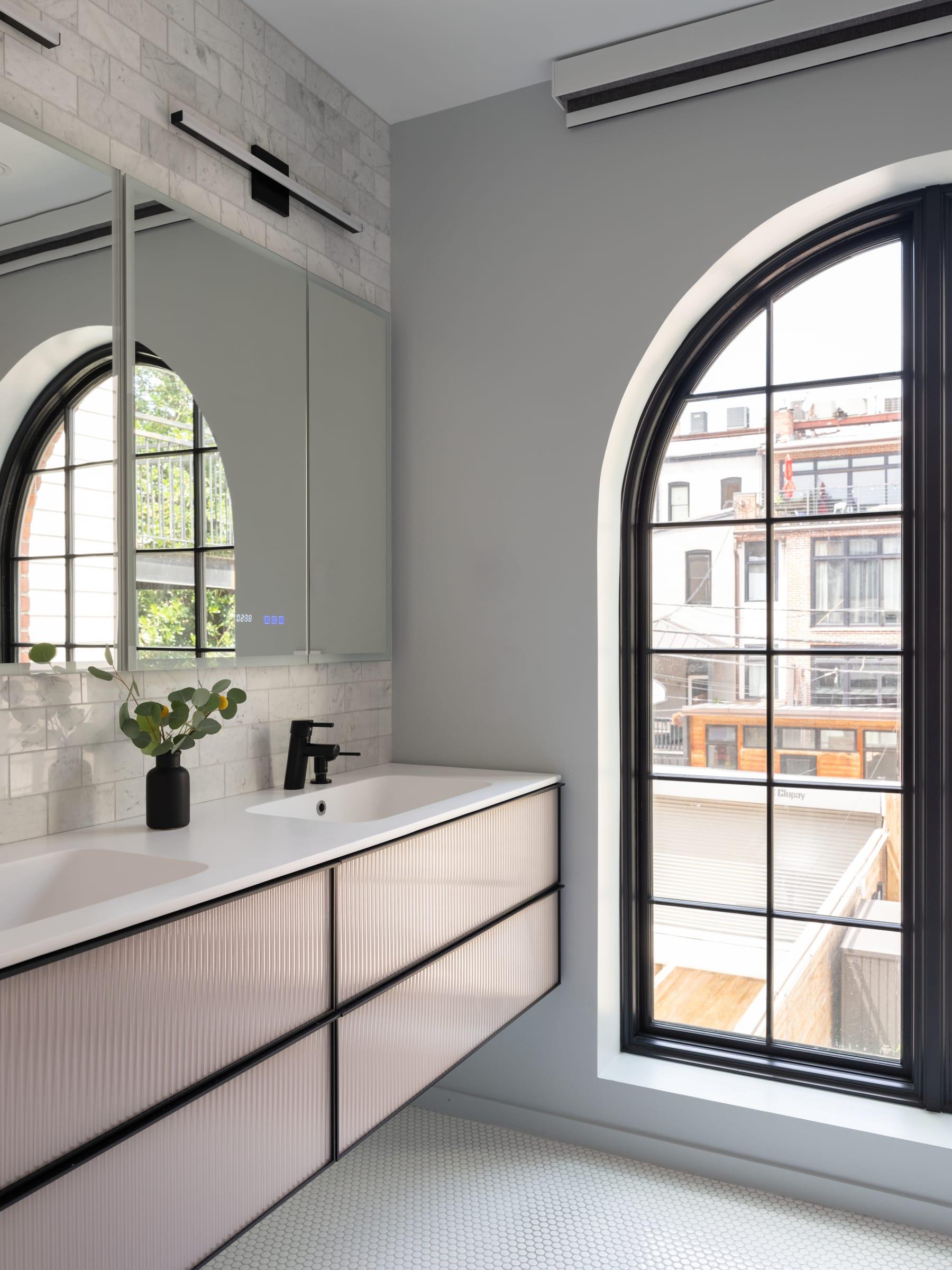 Pink vanity under arched windows