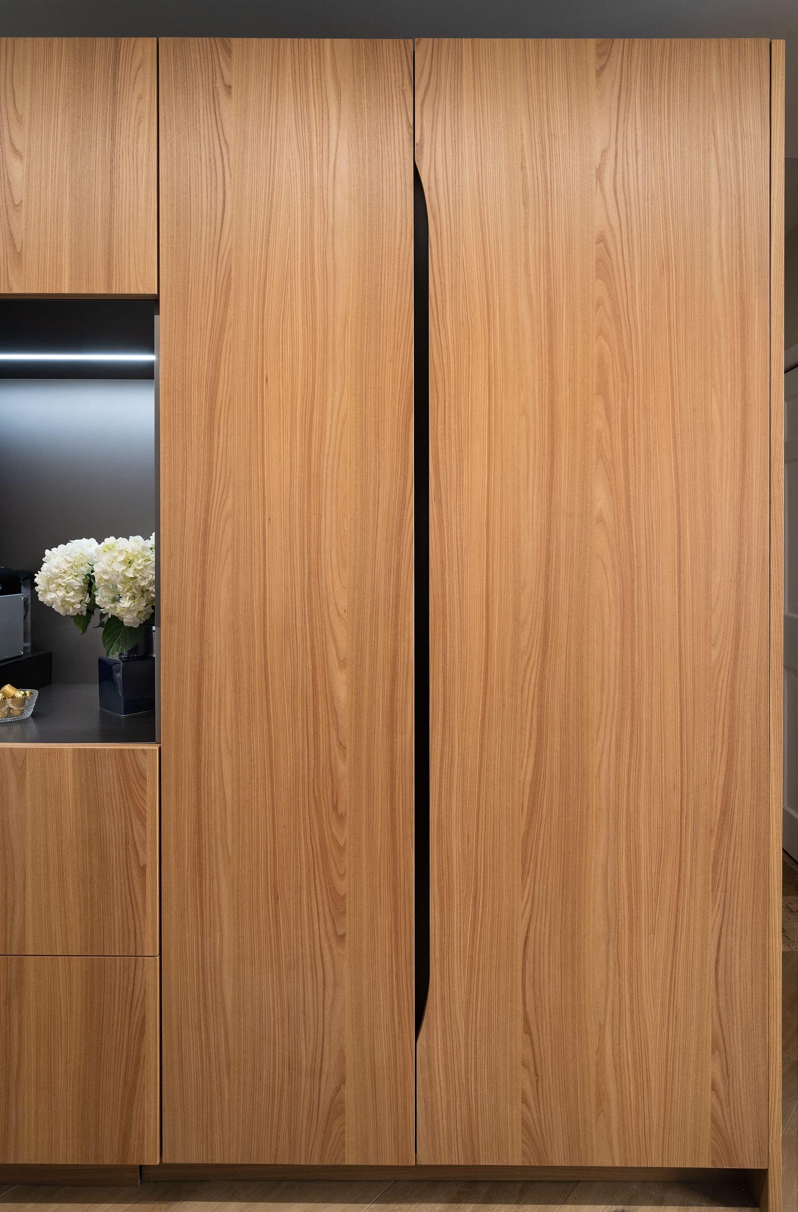 Tall wood units with a carved finger pull