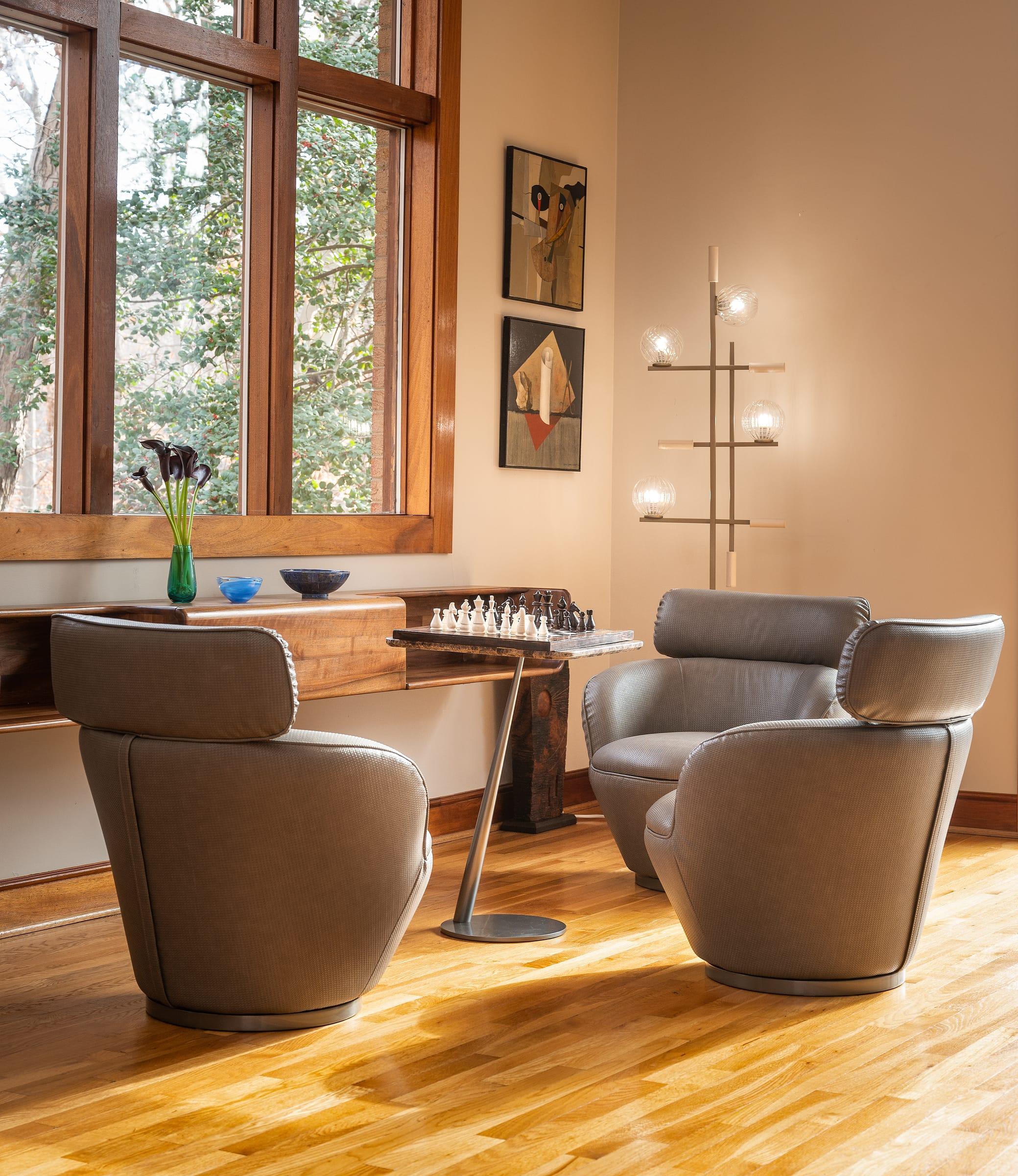Two armchairs by a window with a floor lamp