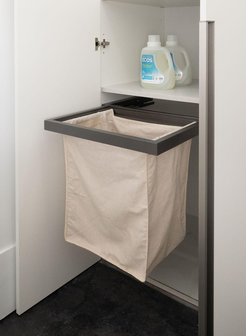 Laundry cabinet with a pull-out hamper