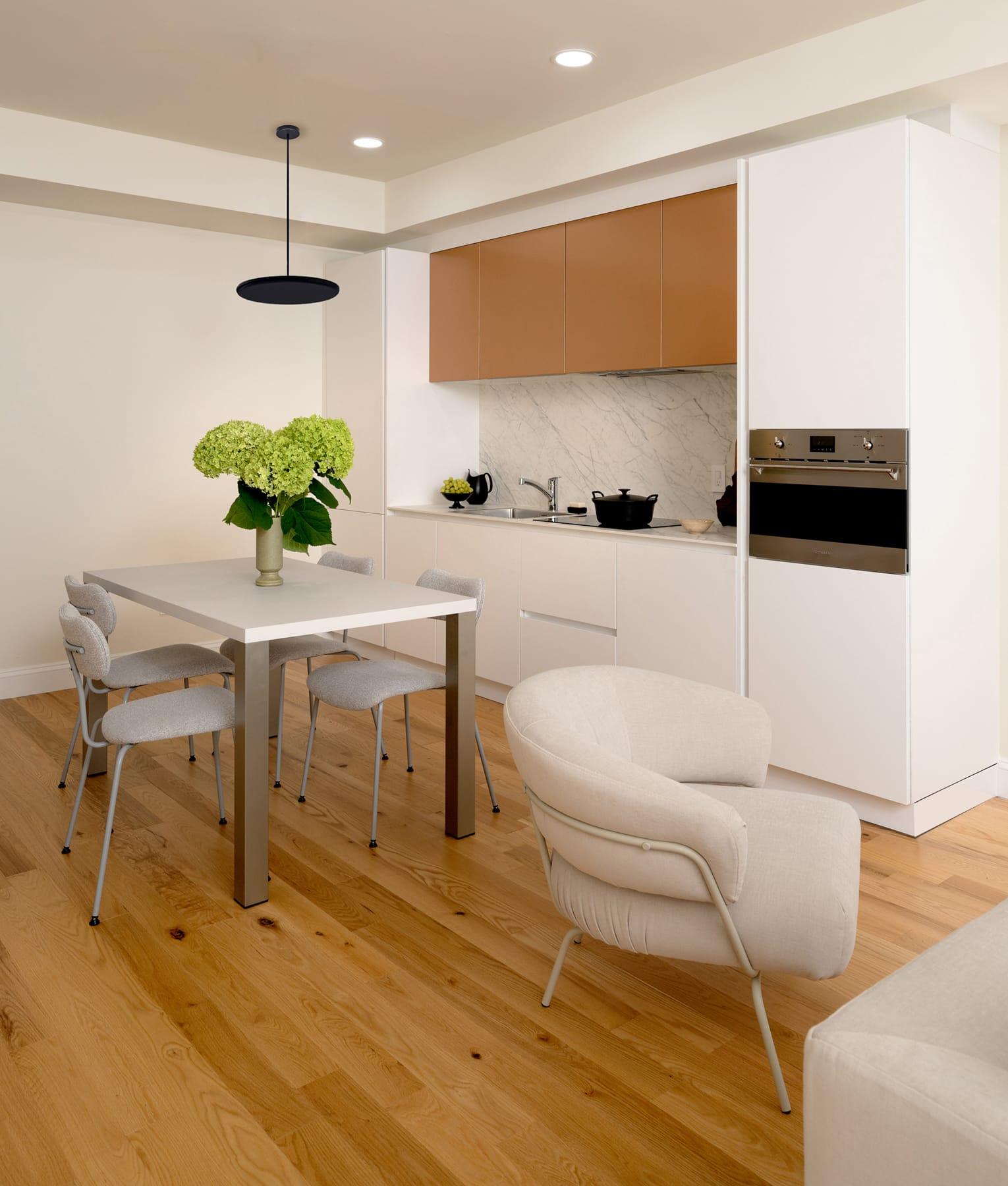 Kitchen with copper wall cabinets and a dining table by the window