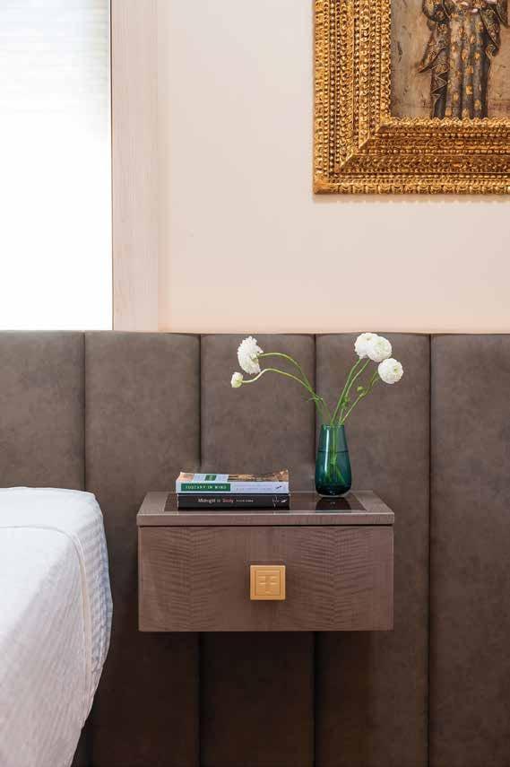 Floating bedside drawer against an upholstered headboard wall