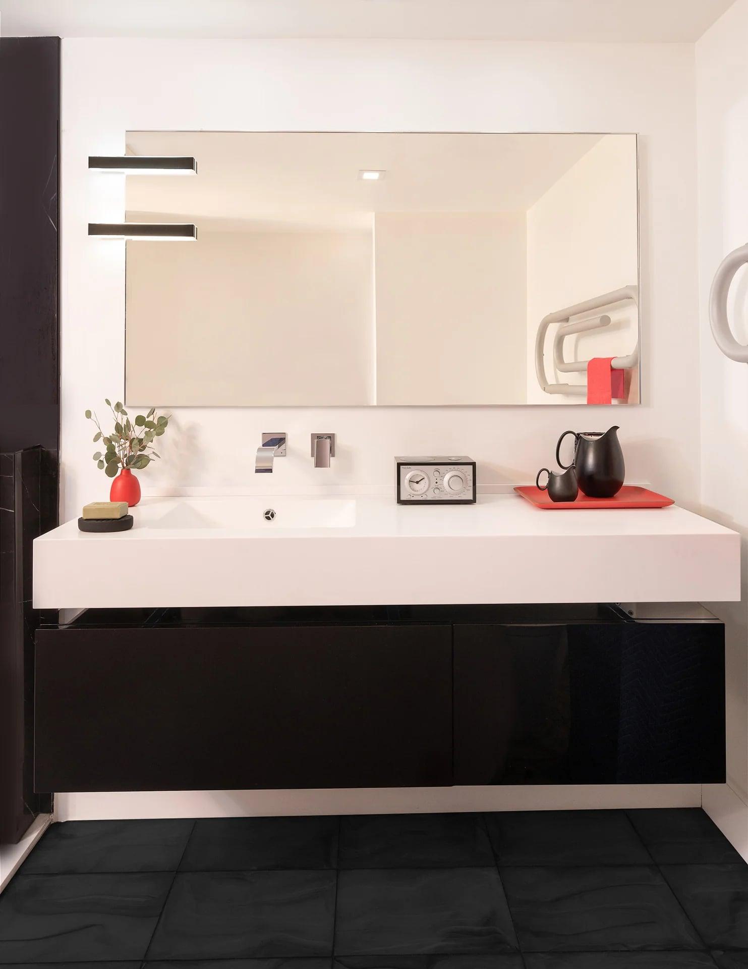 Vanity and mirror beside a doorway