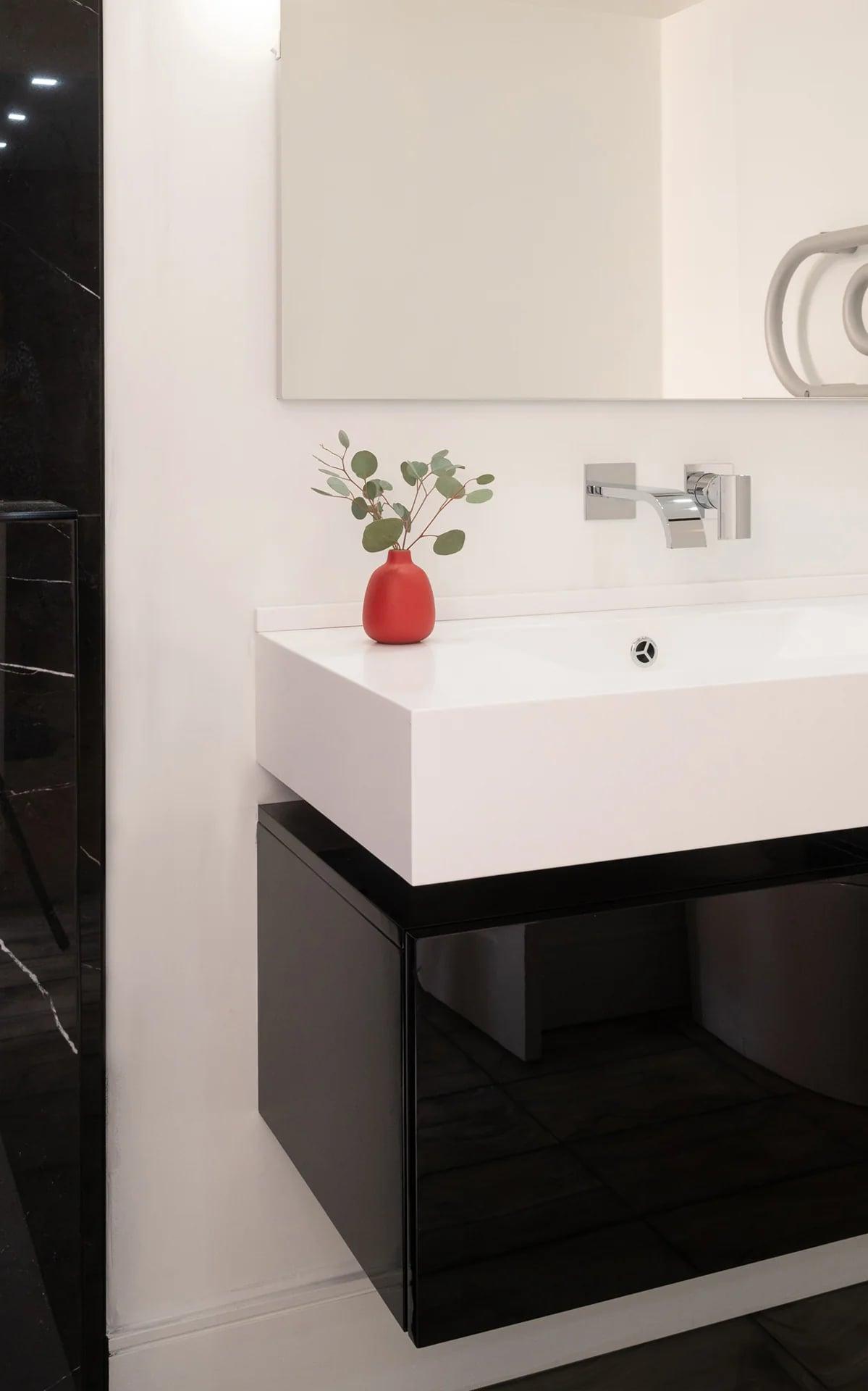 Vanity with a plant and a round mirror