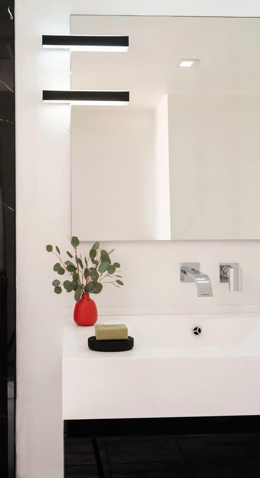 Vanity seen from the side with a black-framed mirror