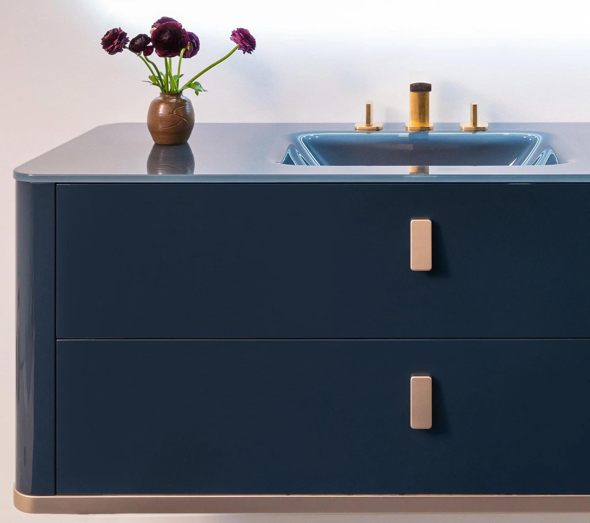 Gloss vanity with a glass front and an integrated basin