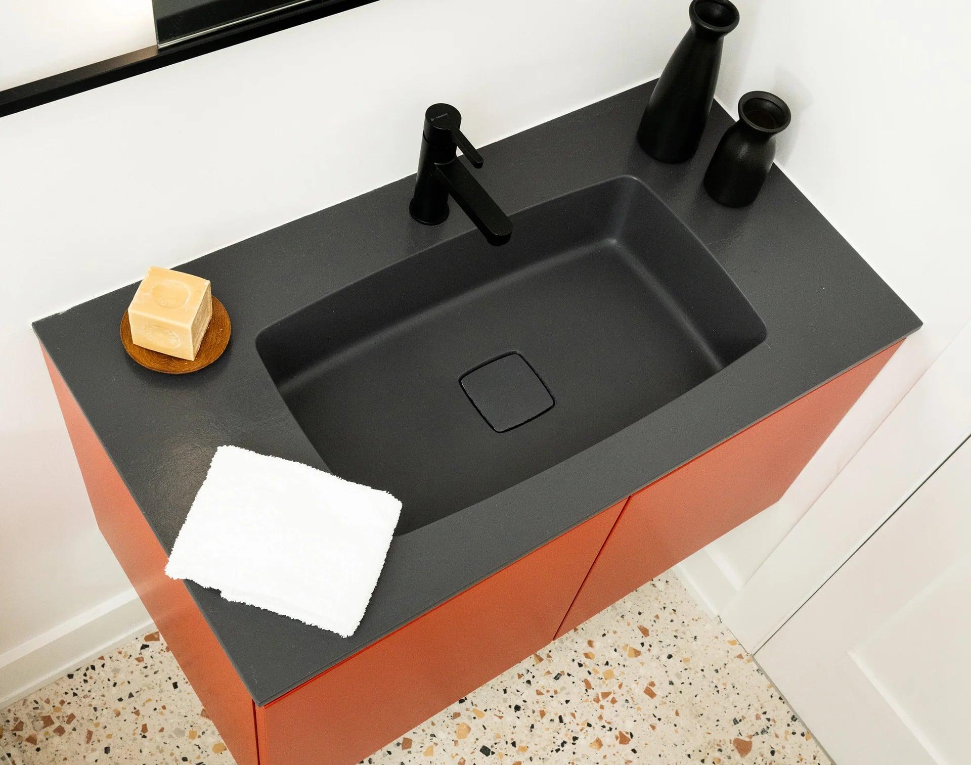 Bathroom with a stone worktop vanity and a large mirror