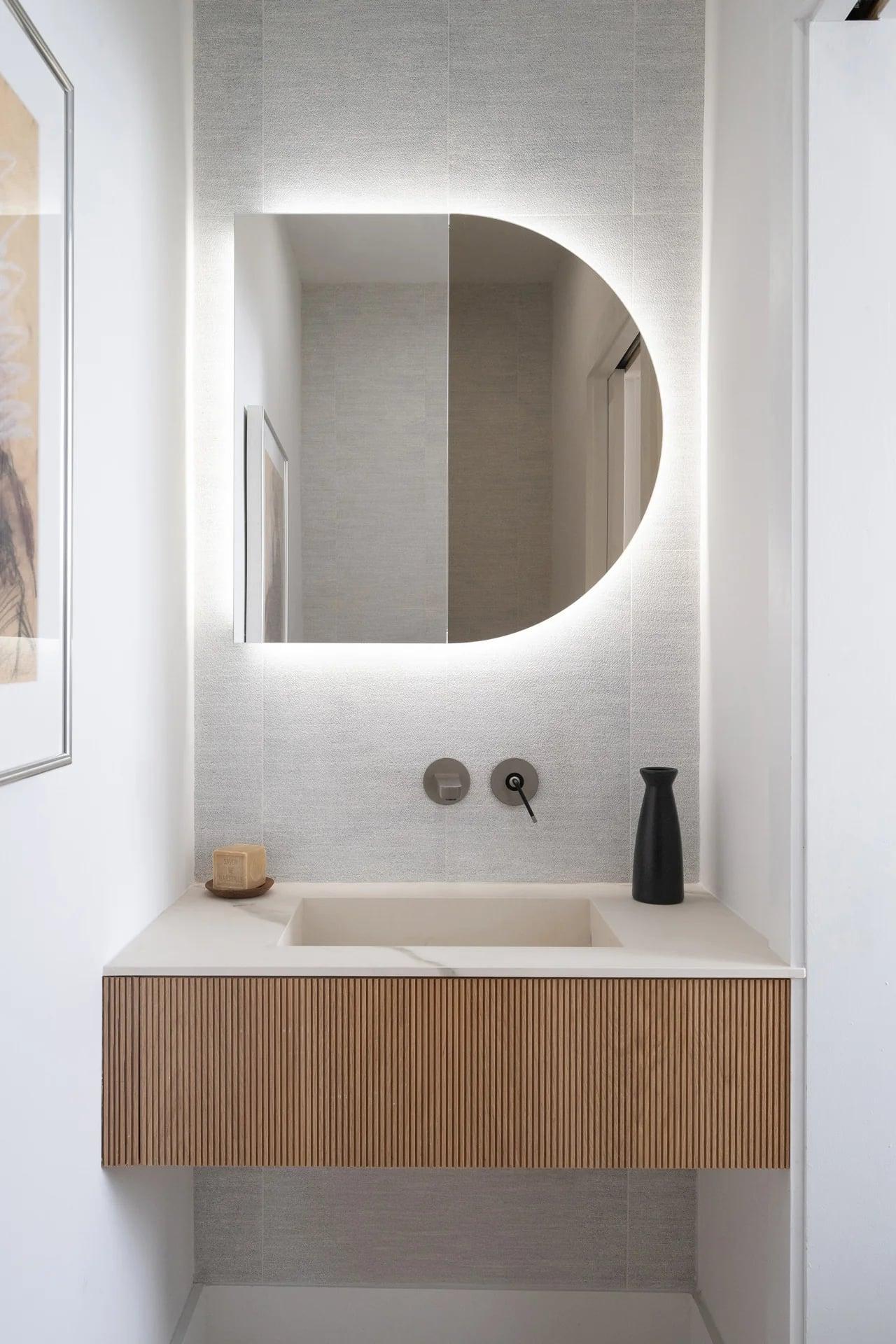 Double vanity in white with two stone basins and wood-clad walls