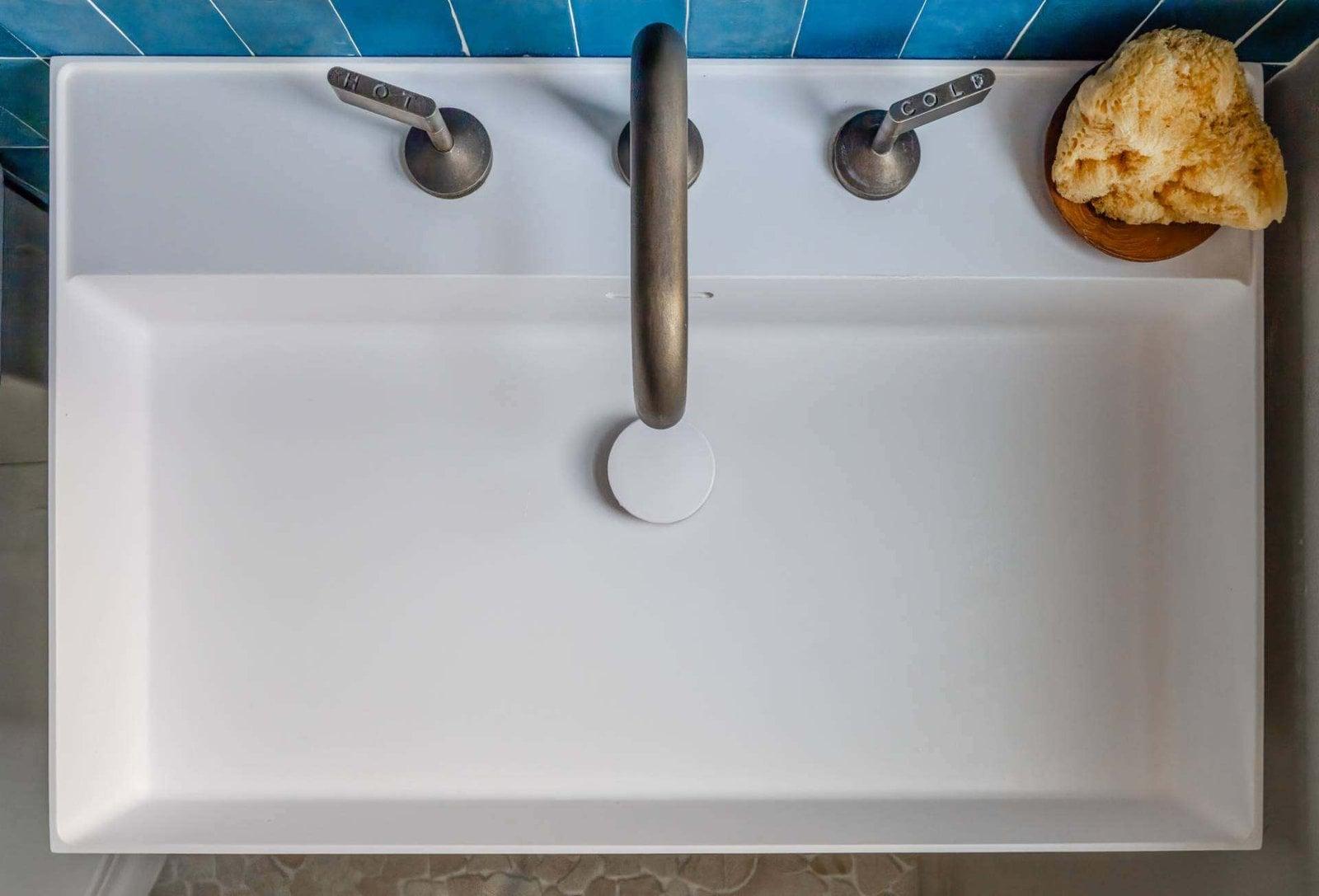 Close-up of the taupe vanity drawers and basin