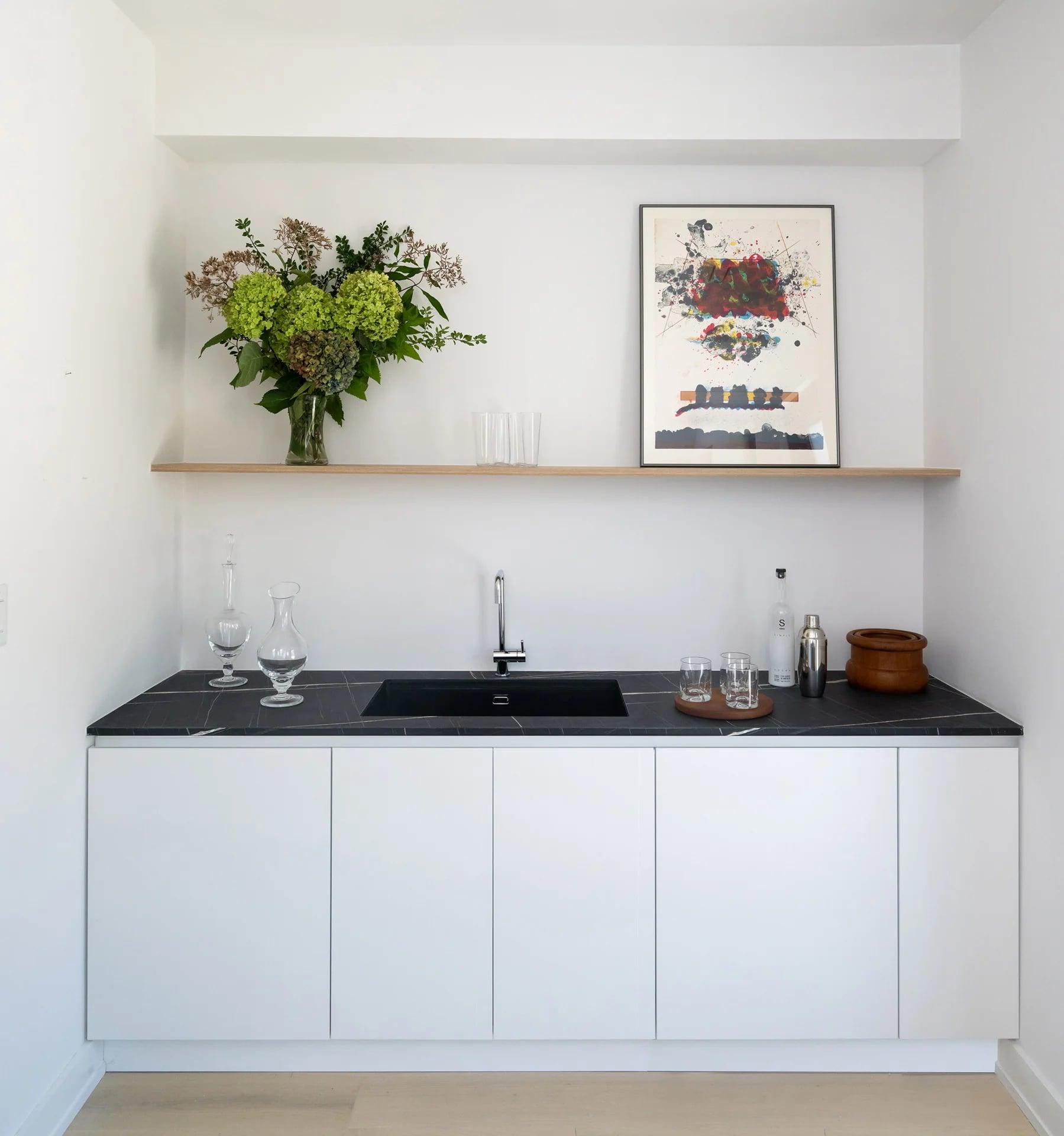 Pull-out laundry hamper inside a cabinet
