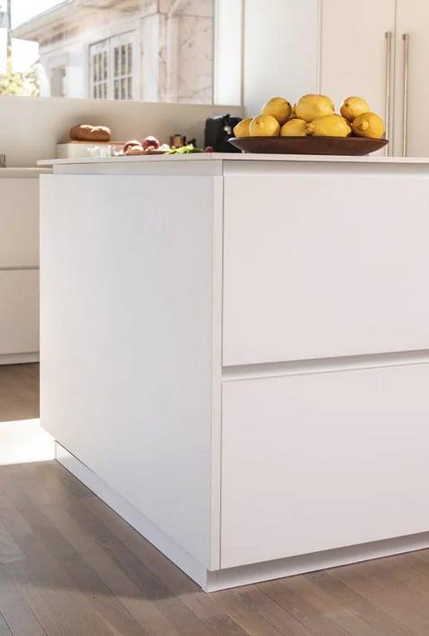 Galley kitchen with a breakfast bar and two black stools