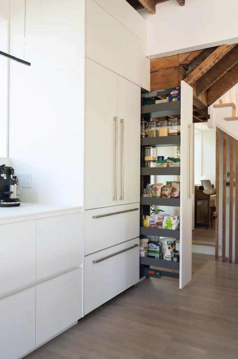 White wall units and base cabinets with a stone splashback