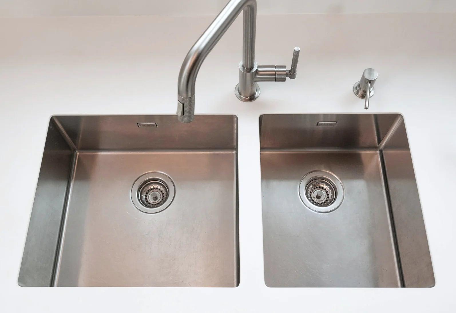 Full-height white units with an integrated sink run