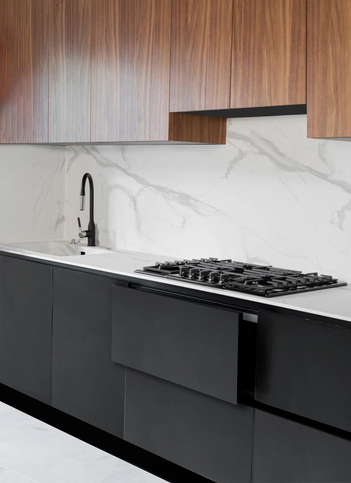 Marble-look Solidtop island with herbs on a walnut board and a black pot