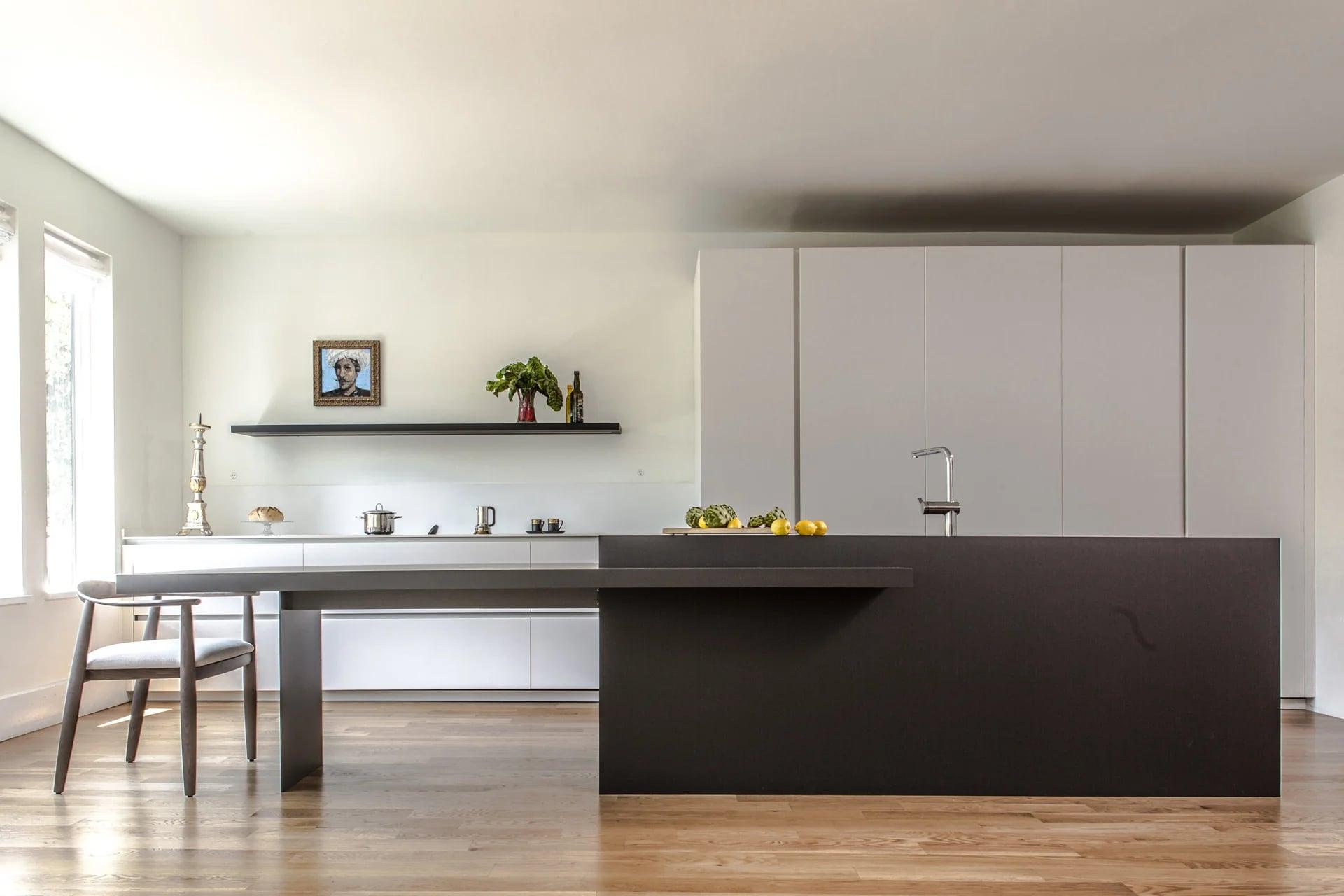 Kitchen island with an integrated sink and a tall stainless-steel tap