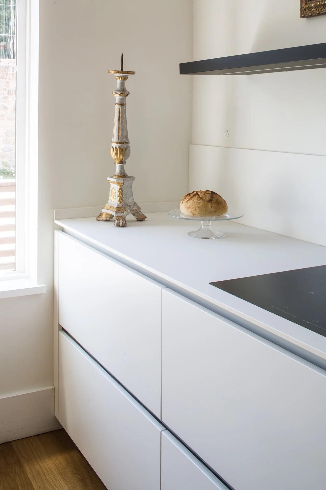 Wall units and a row of glass jars along the white kitchen
