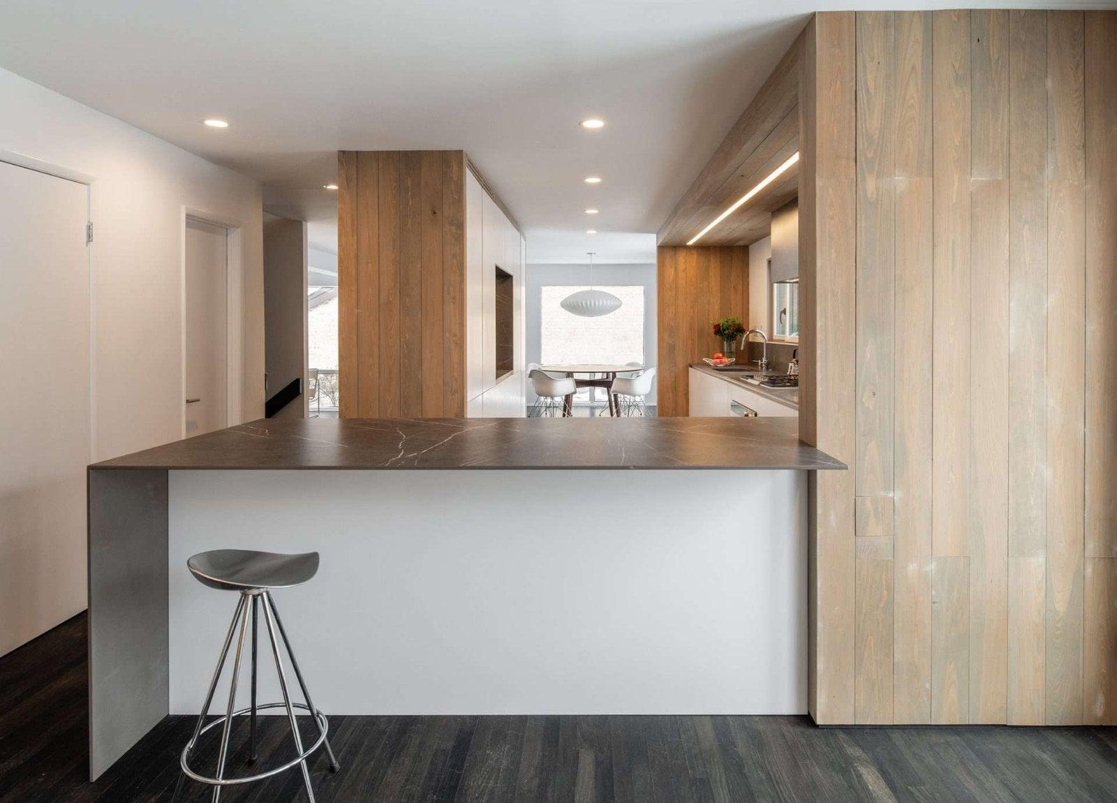 Peninsula with a stone worktop and a metal stool