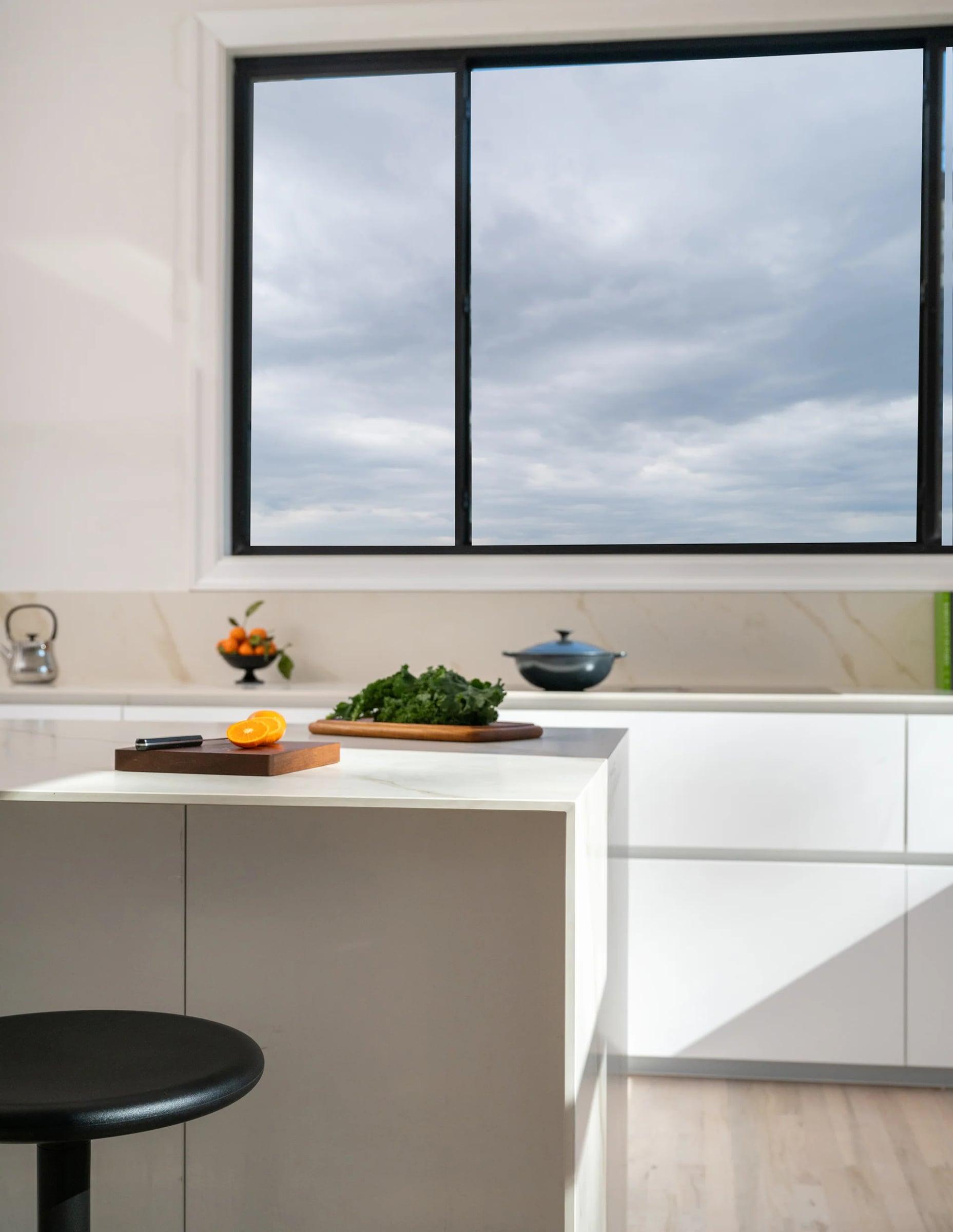 Black island with an induction hob and a framed portrait