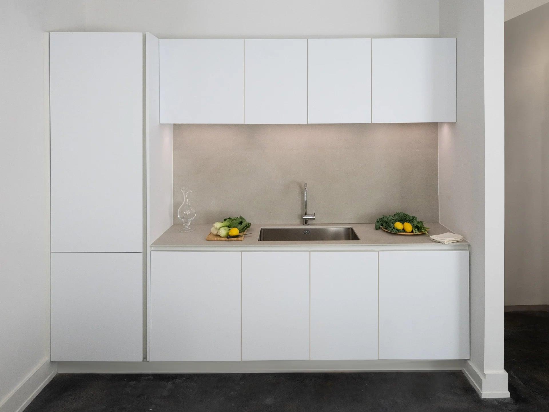Kitchen run with pale wood doors and open shelves