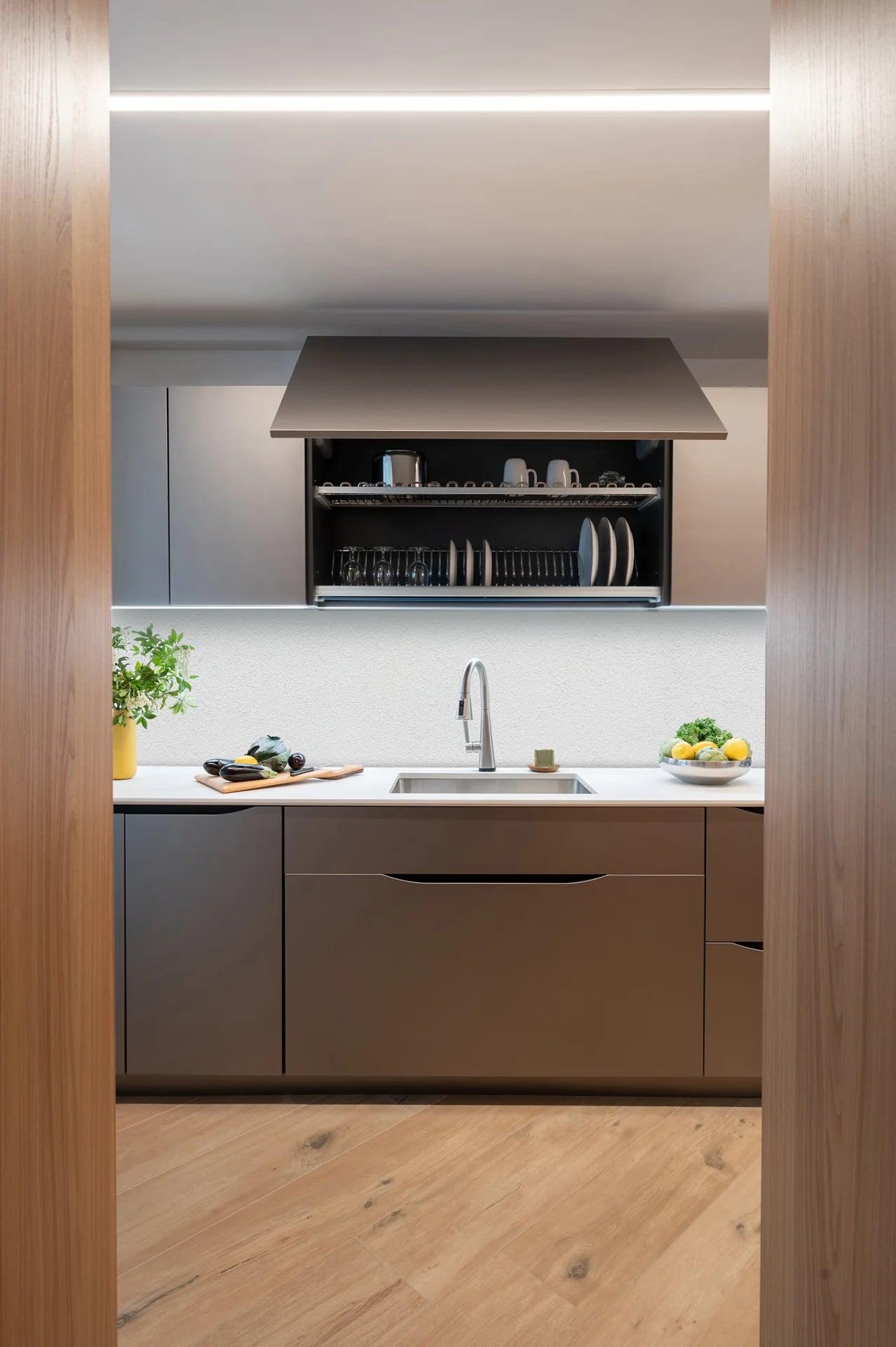 Black and walnut kitchen with a white marble splashback