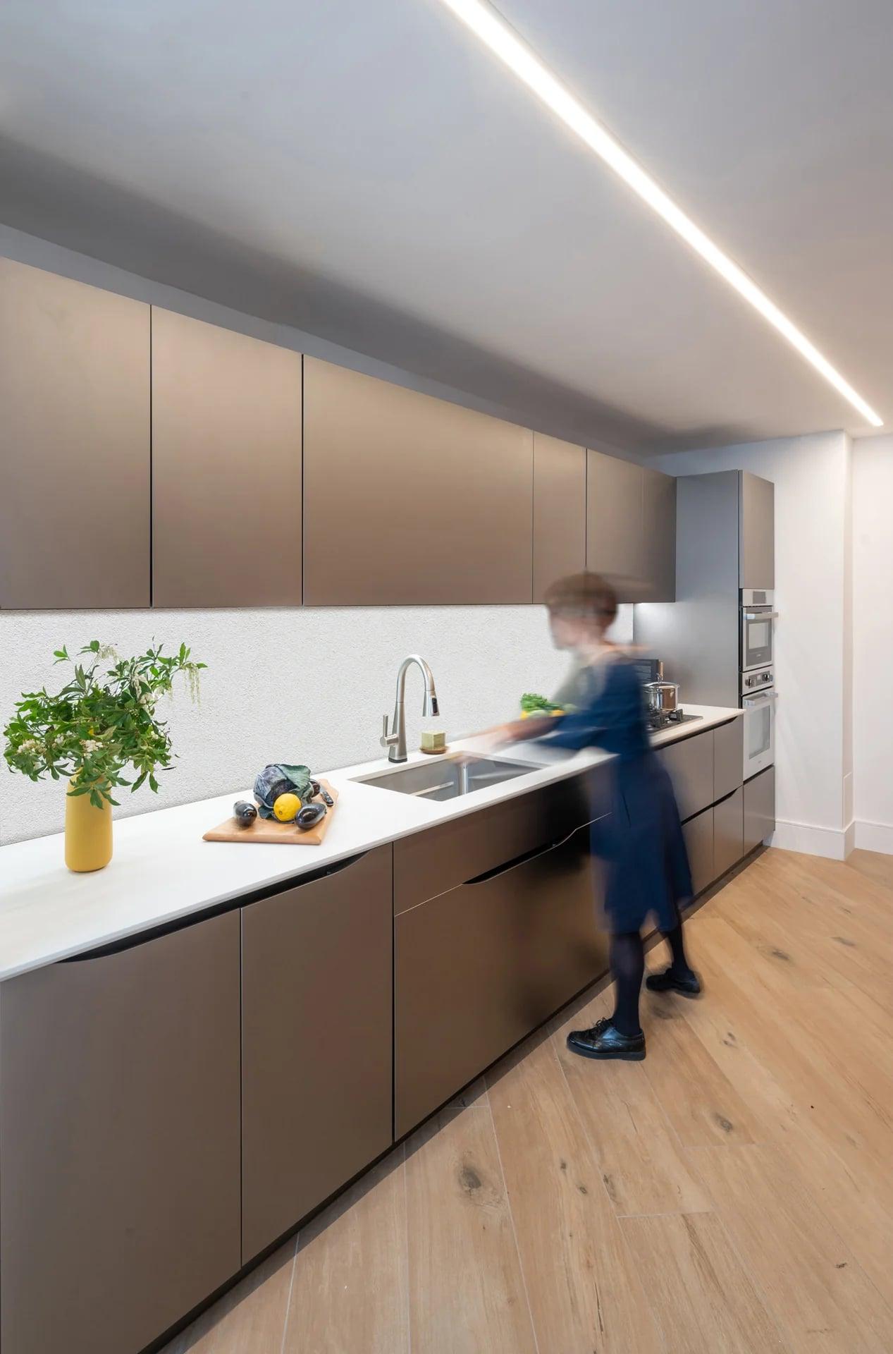 Black cabinets and walnut units with a gas hob