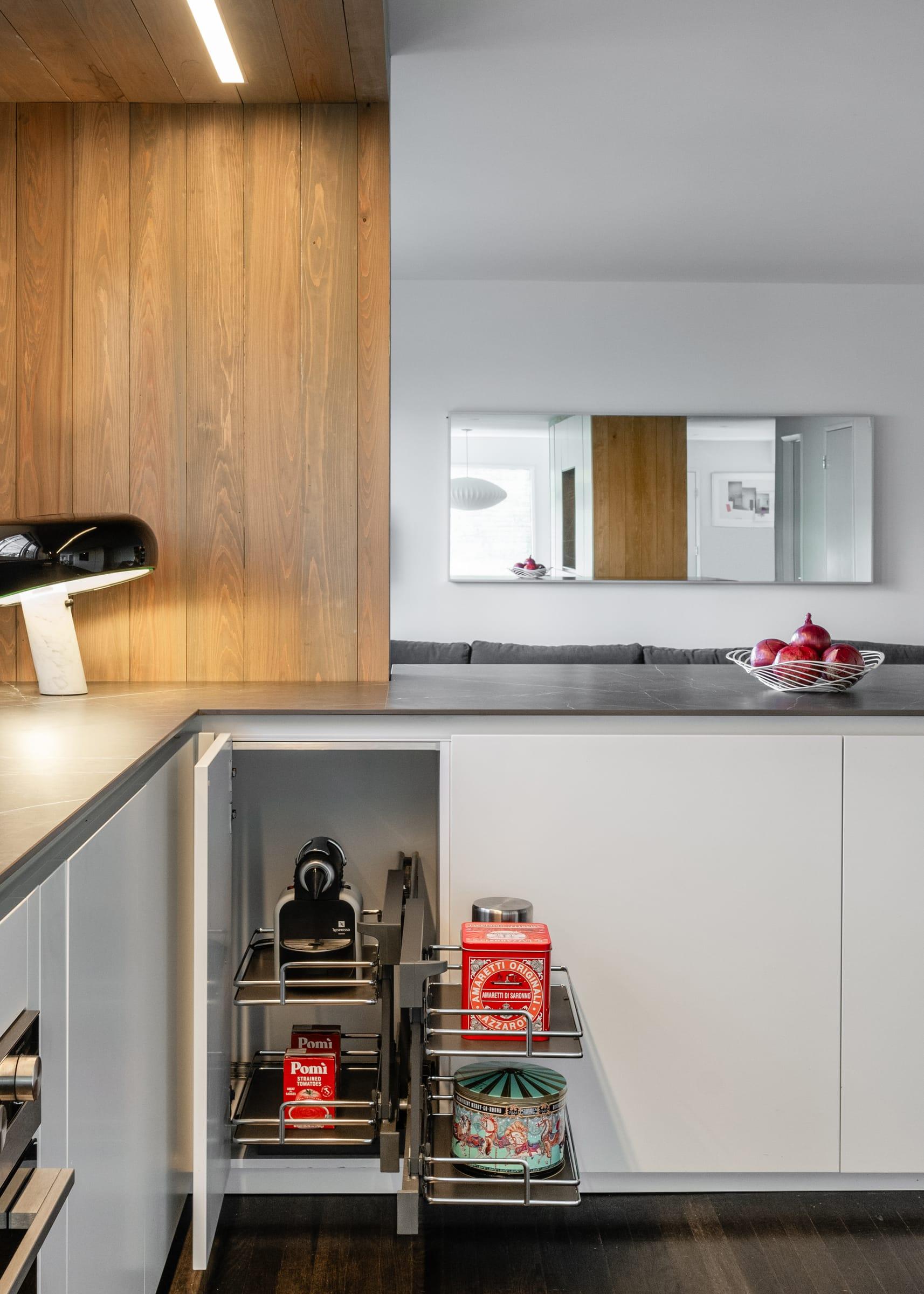 Corner unit pulled out under a wood-clad wall