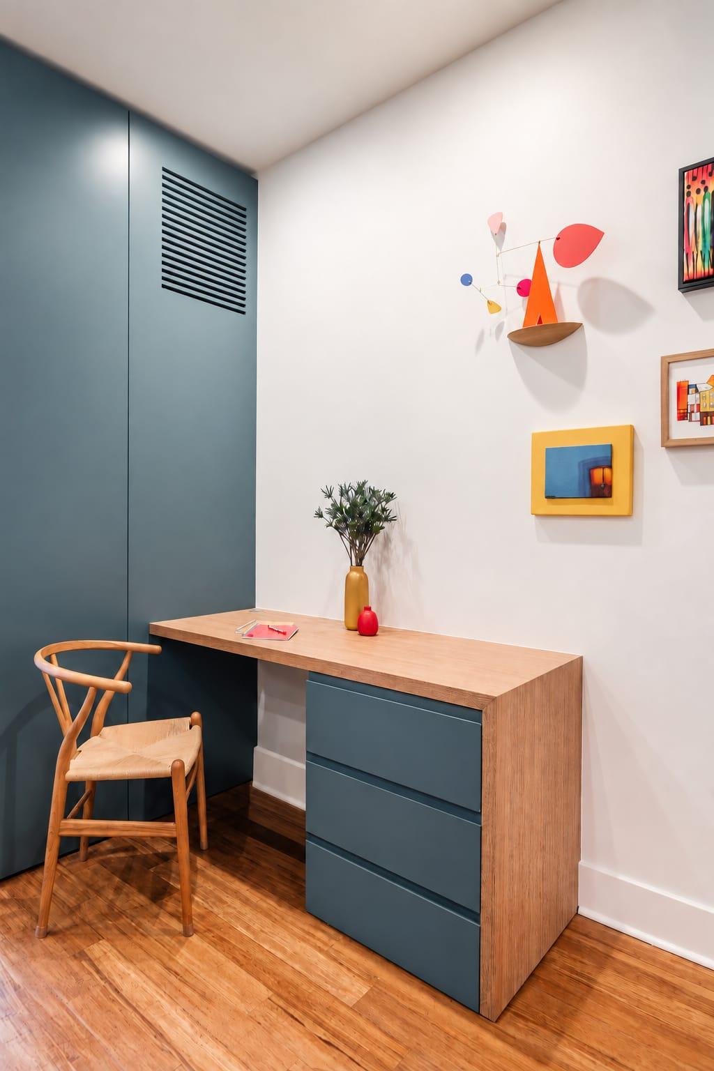 Grey-green tall unit beside a small desk and a wood chair