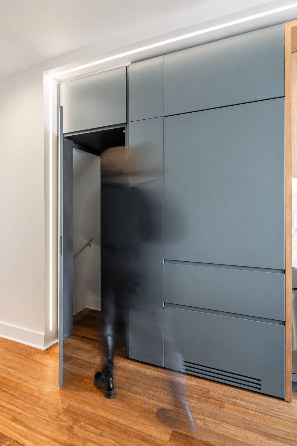 Grey-green tall units with a hidden door ajar