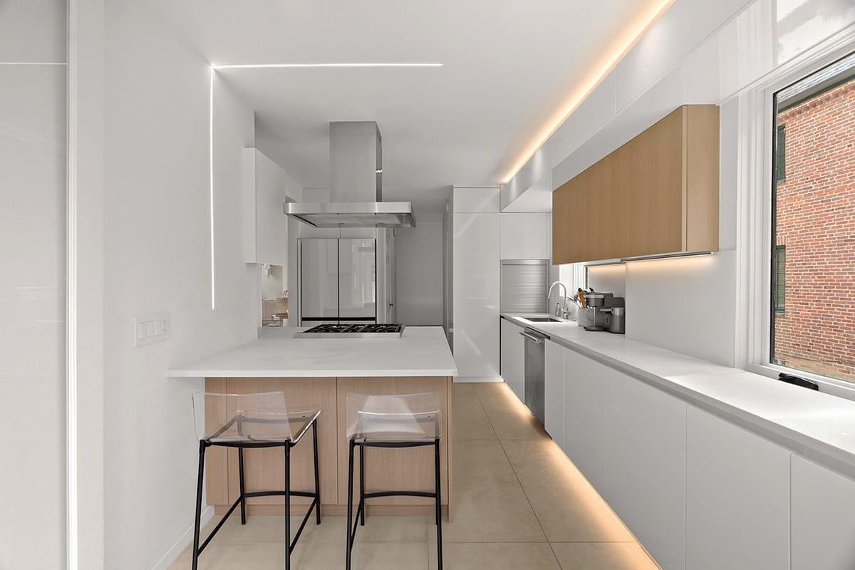 White and oak kitchen with stools at the counter