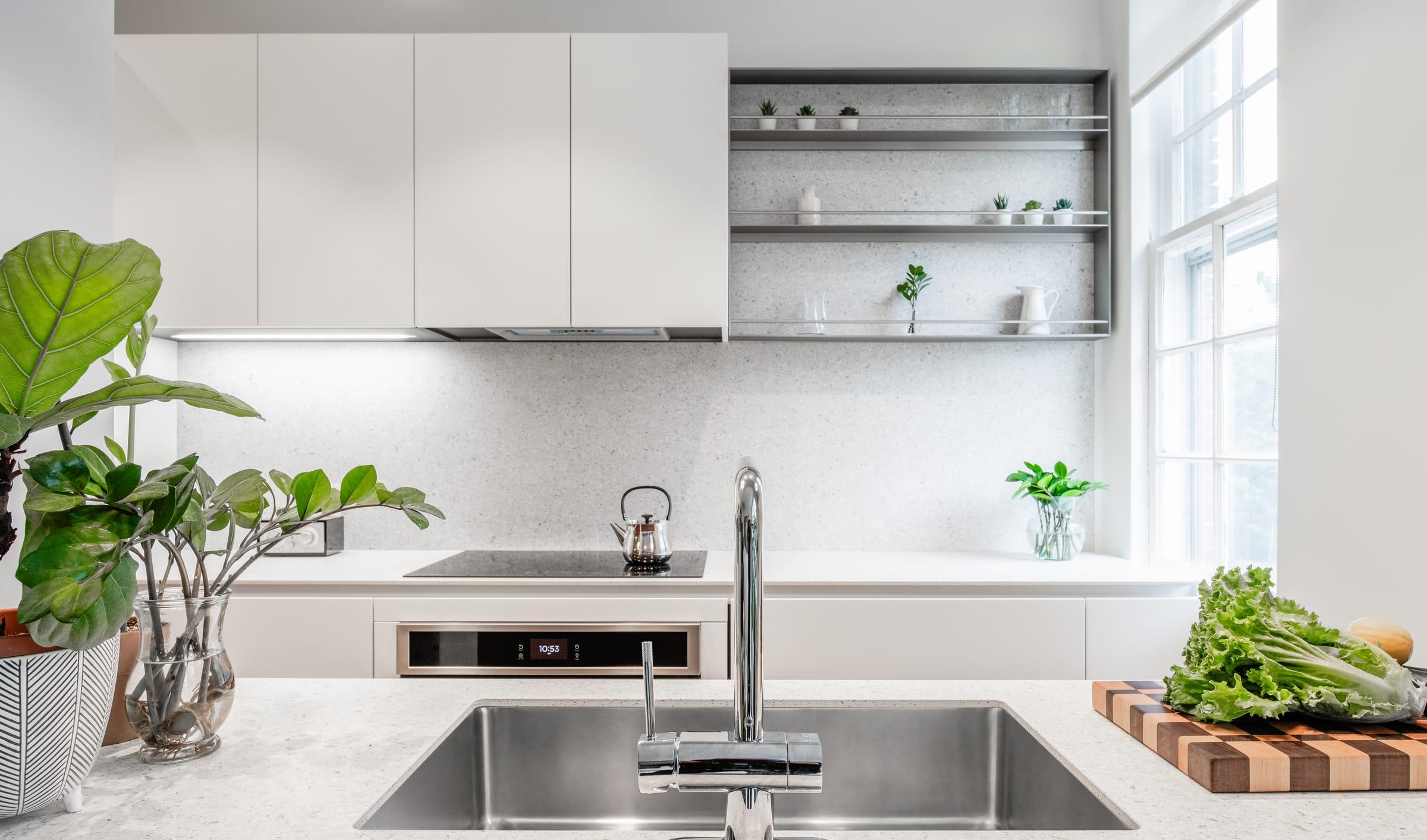 Steel sink under open shelves and white wall cabinets