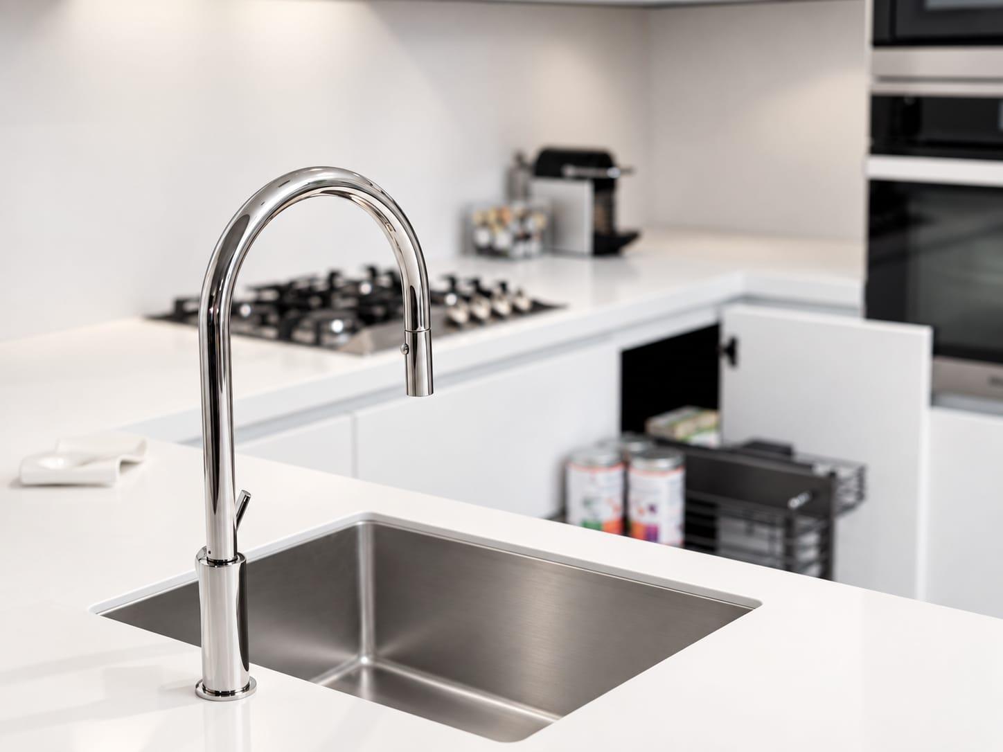 Steel sink with a tall tap in a white worktop