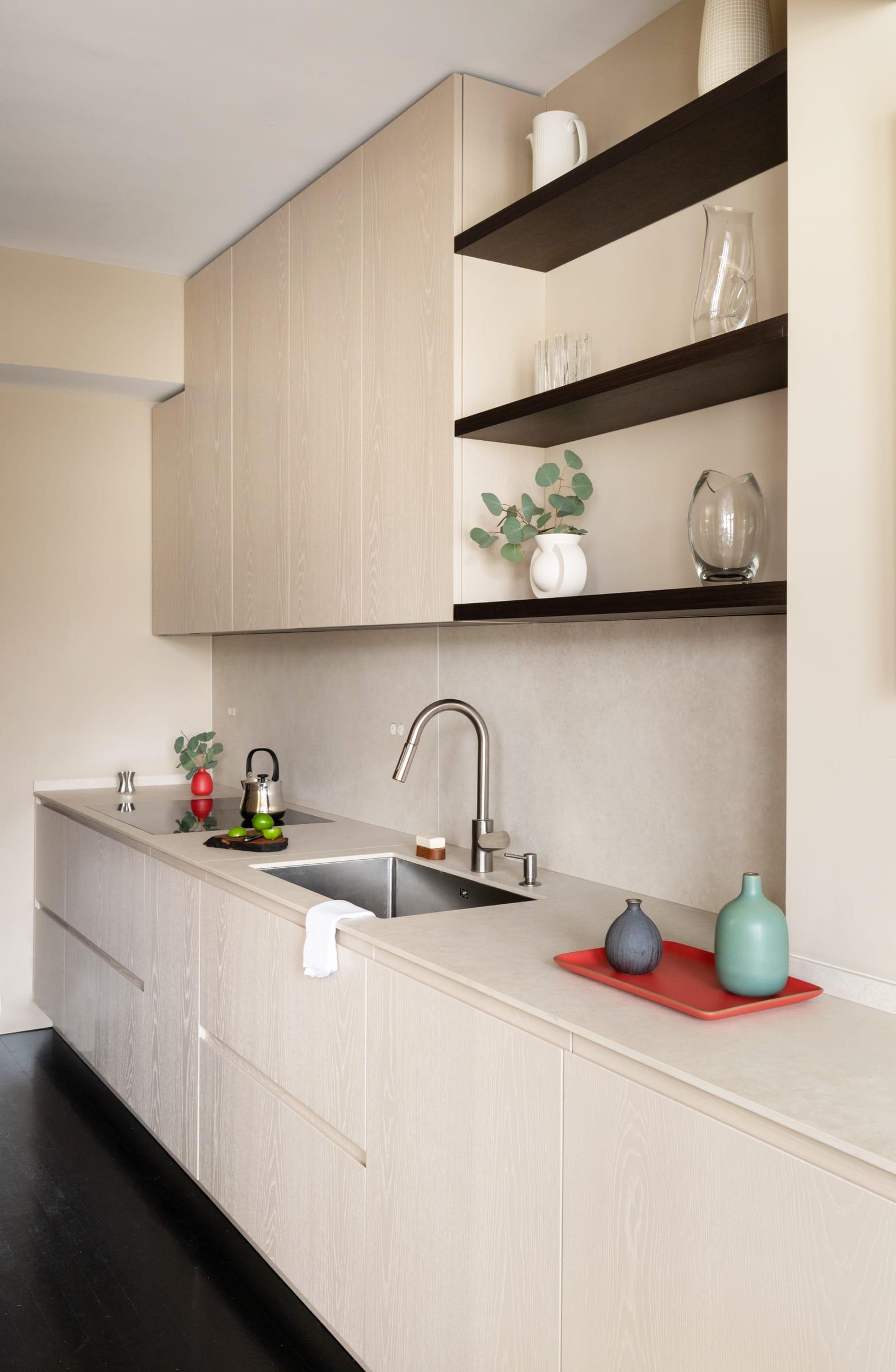 Pale kitchen with dark open shelves over the sink