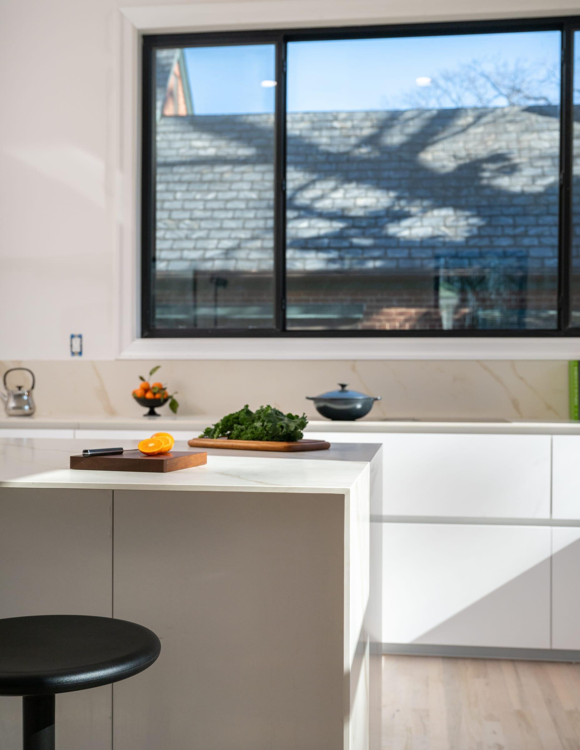 Marble island with a stool under a wide window