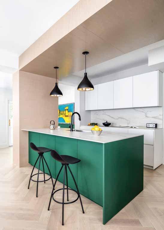 Green island with black stools under black pendants