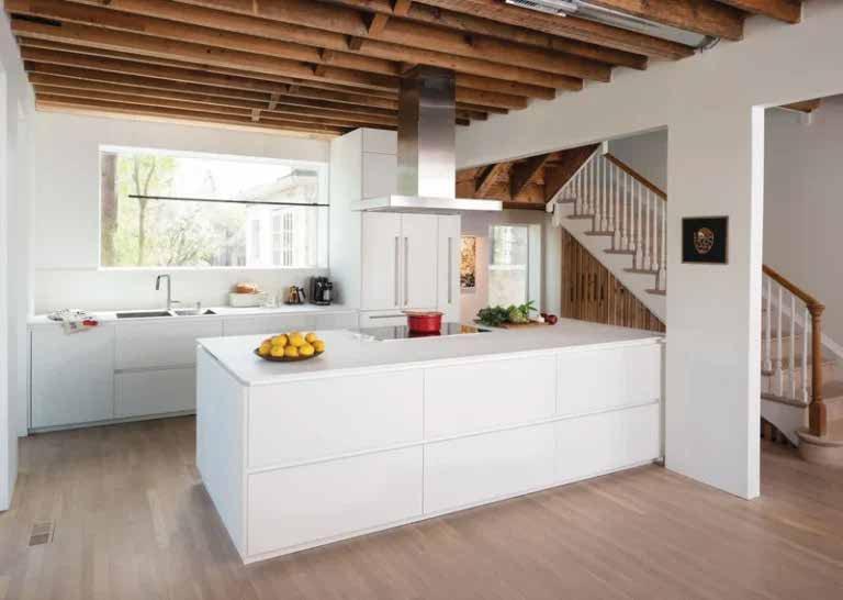 White island under exposed beams with a staircase beside it