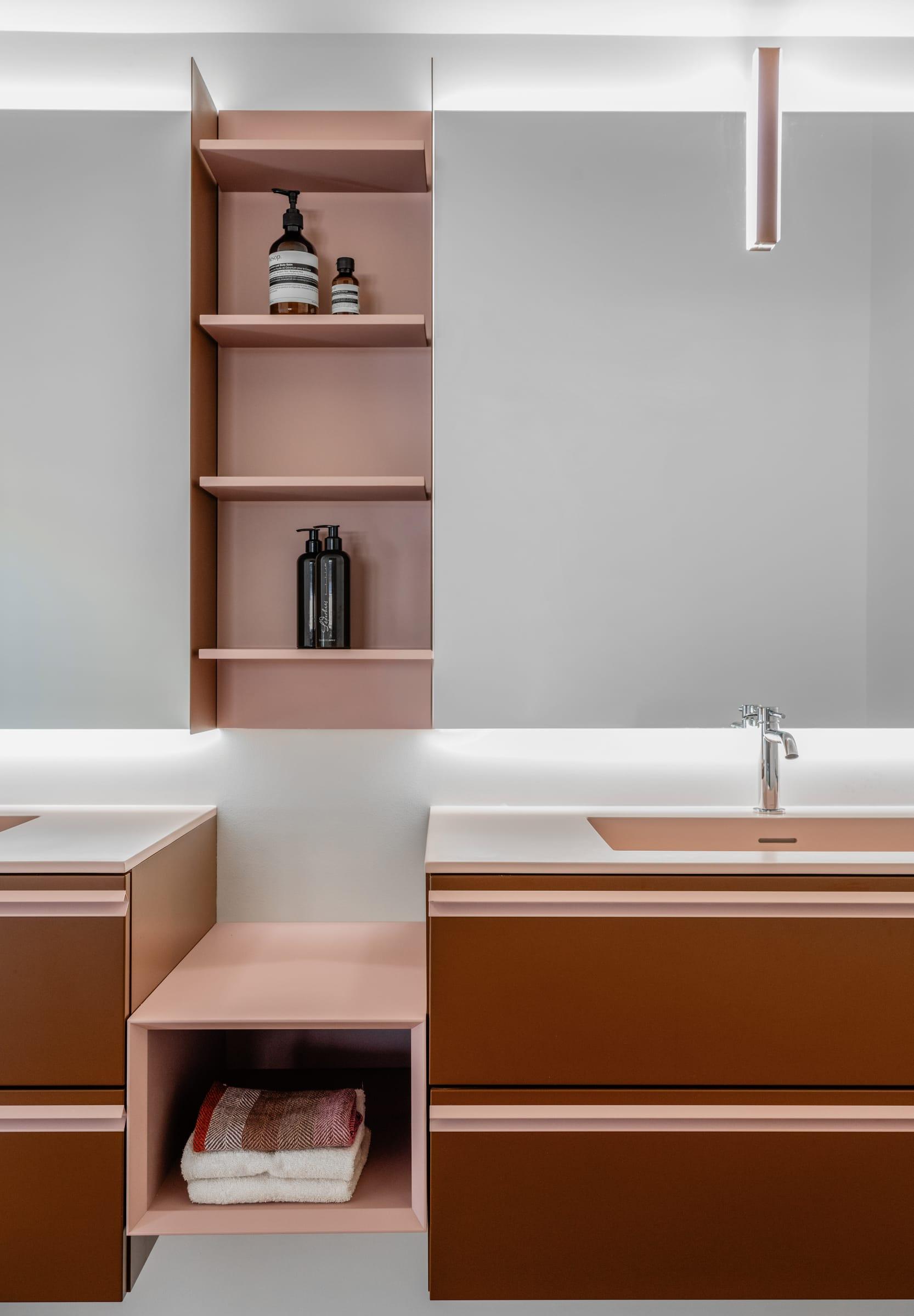 Walnut vanity with open shelves under a mirror cabinet
