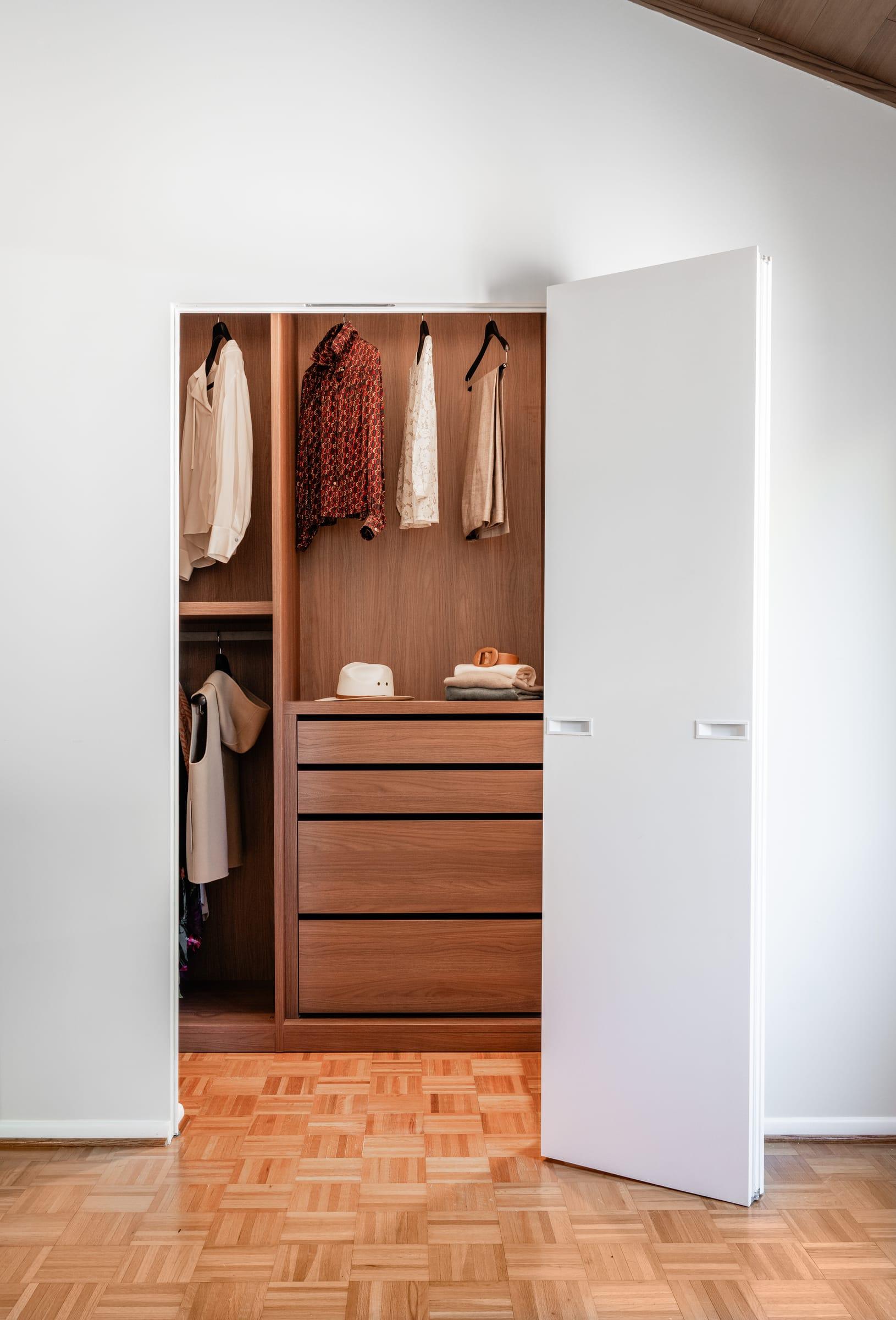 Walk-in wardrobe through an open door