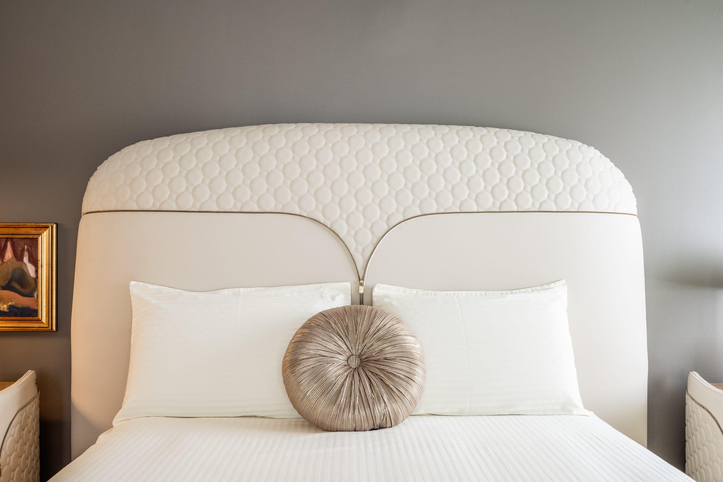 Upholstered headboard with a round cushion