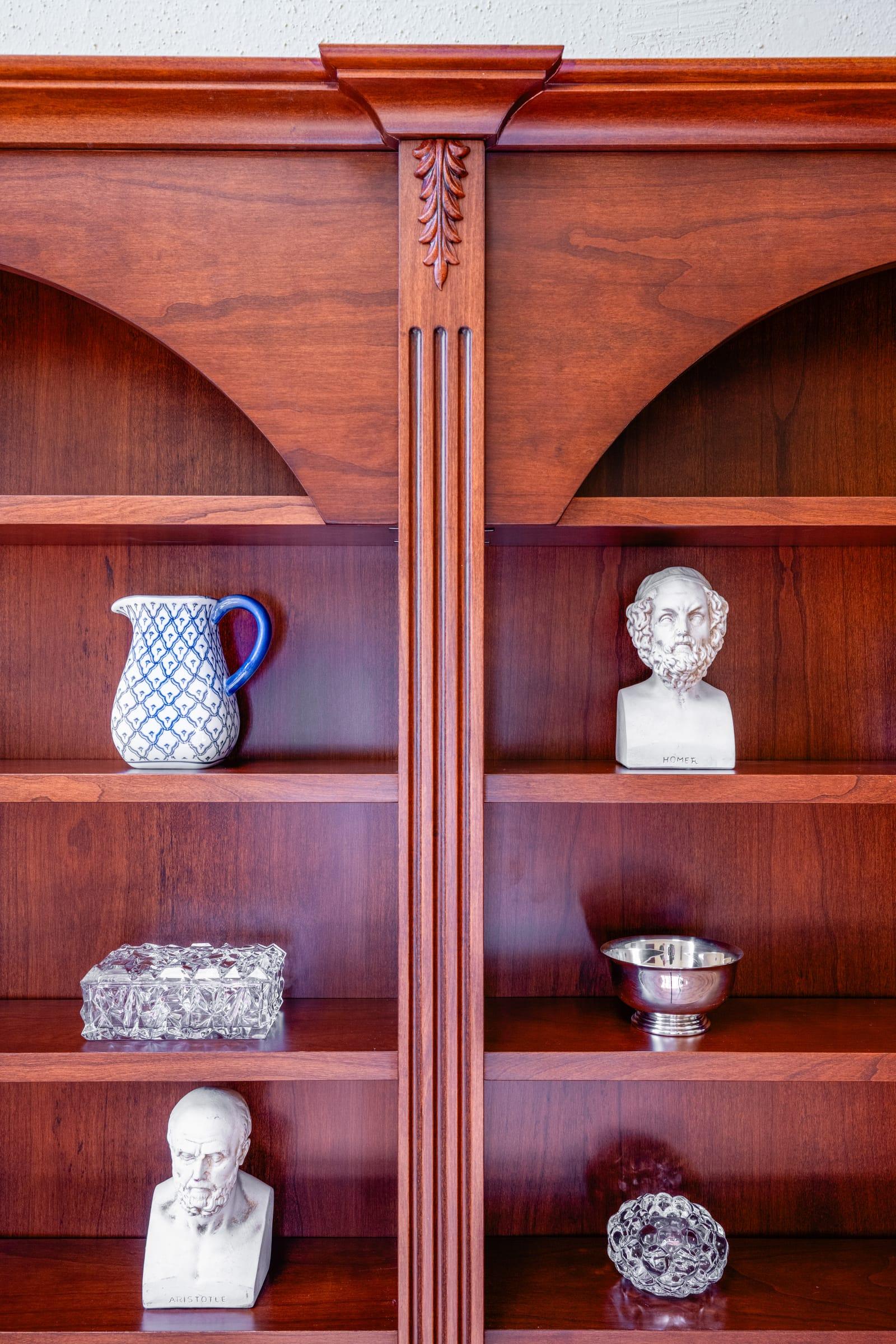 Cherry wood niches with a jug and plaster busts