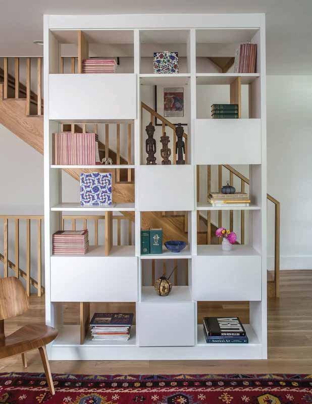 White open bookcase with books and objects in square niches