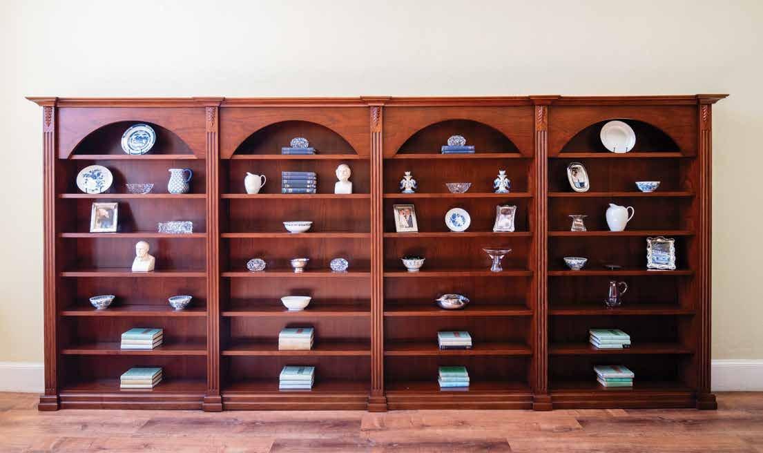 Cherry wood bookcase with arched niches holding china