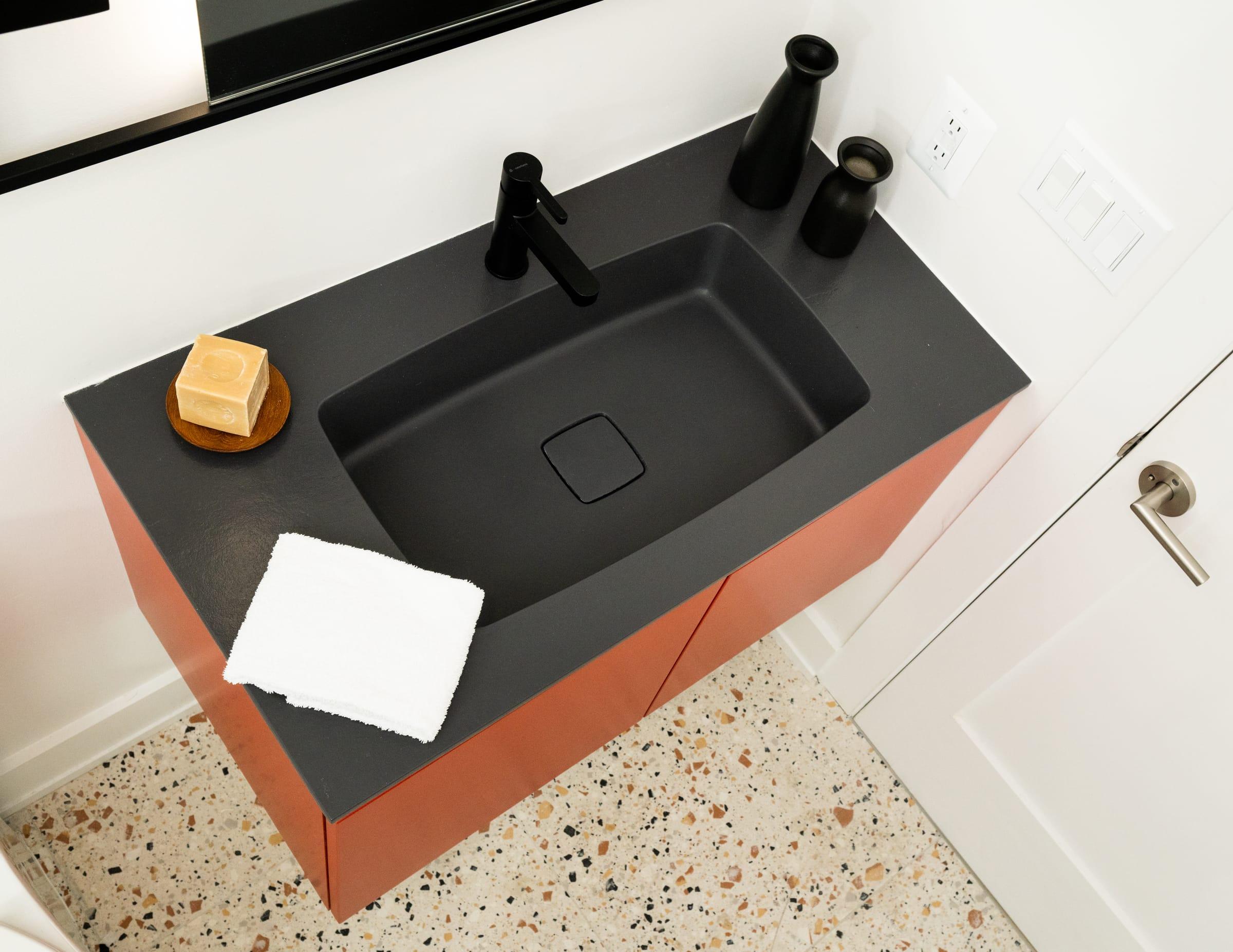 Red vanity with a black basin, seen from above