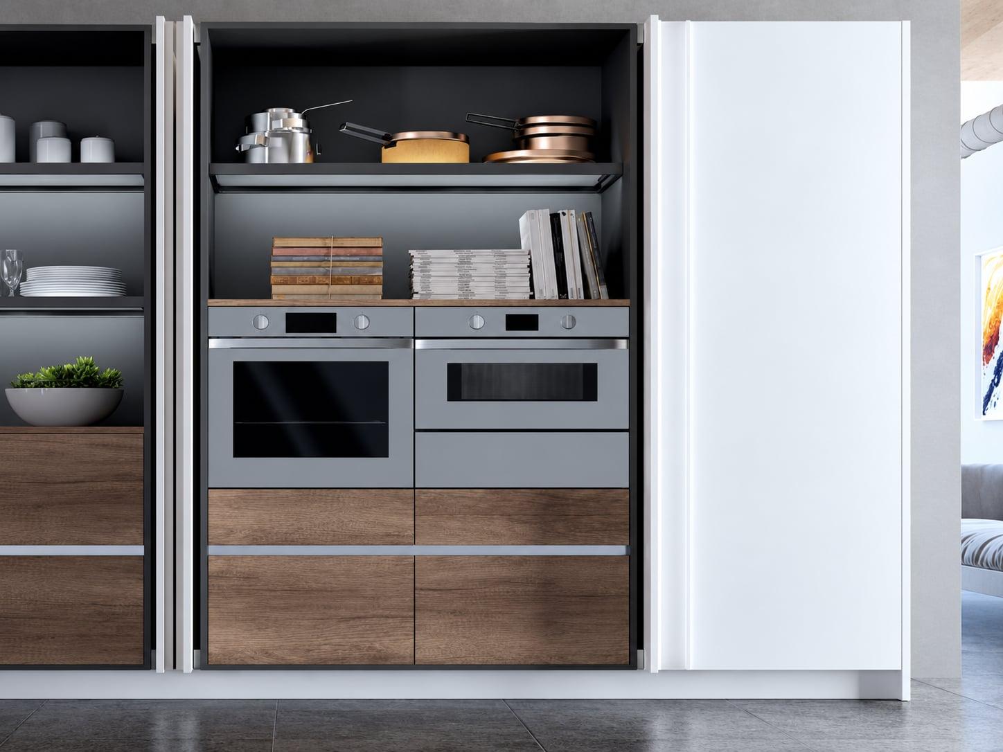 Pantry with pocket doors open onto shelves, two built-in ovens and wood drawers