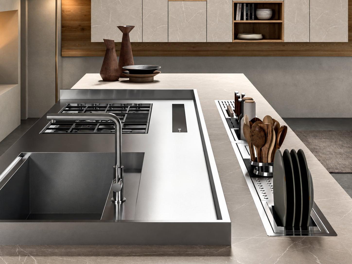 Steel kitchen island with a sink, a hob and a recessed rail of utensils and plates