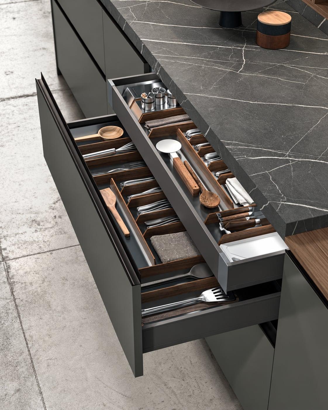 Deep drawer with a wood cutlery insert beside a marble counter