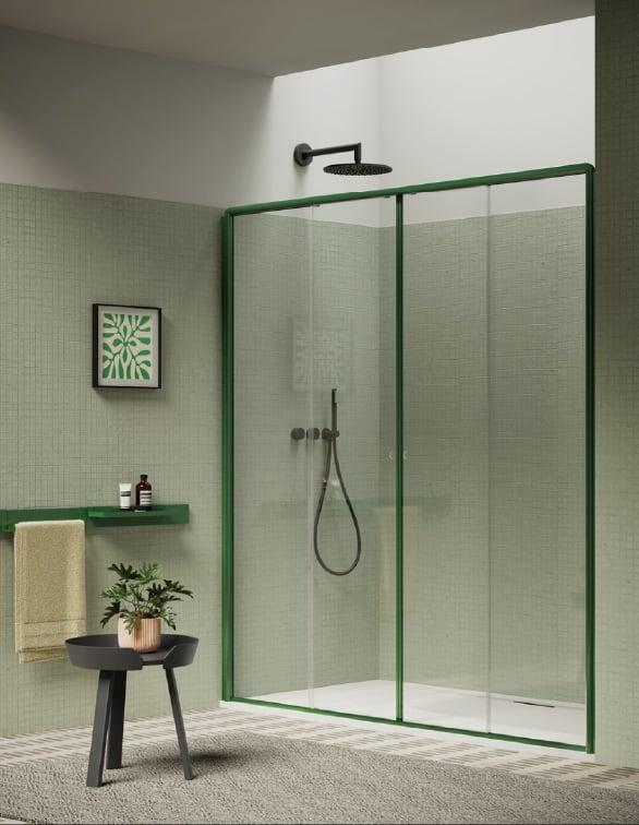 Walk-in shower with green-framed glass doors, a black stool and a plant beside it