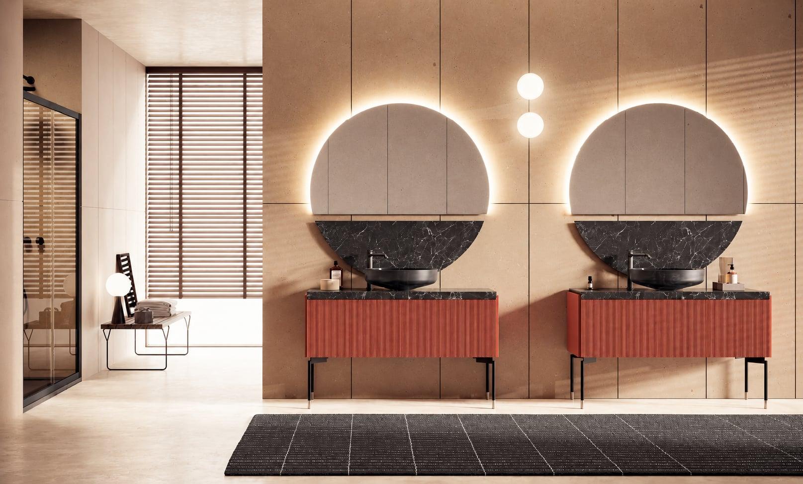 Two red vanities with black basins under round backlit mirrors, a walk-in shower beyond