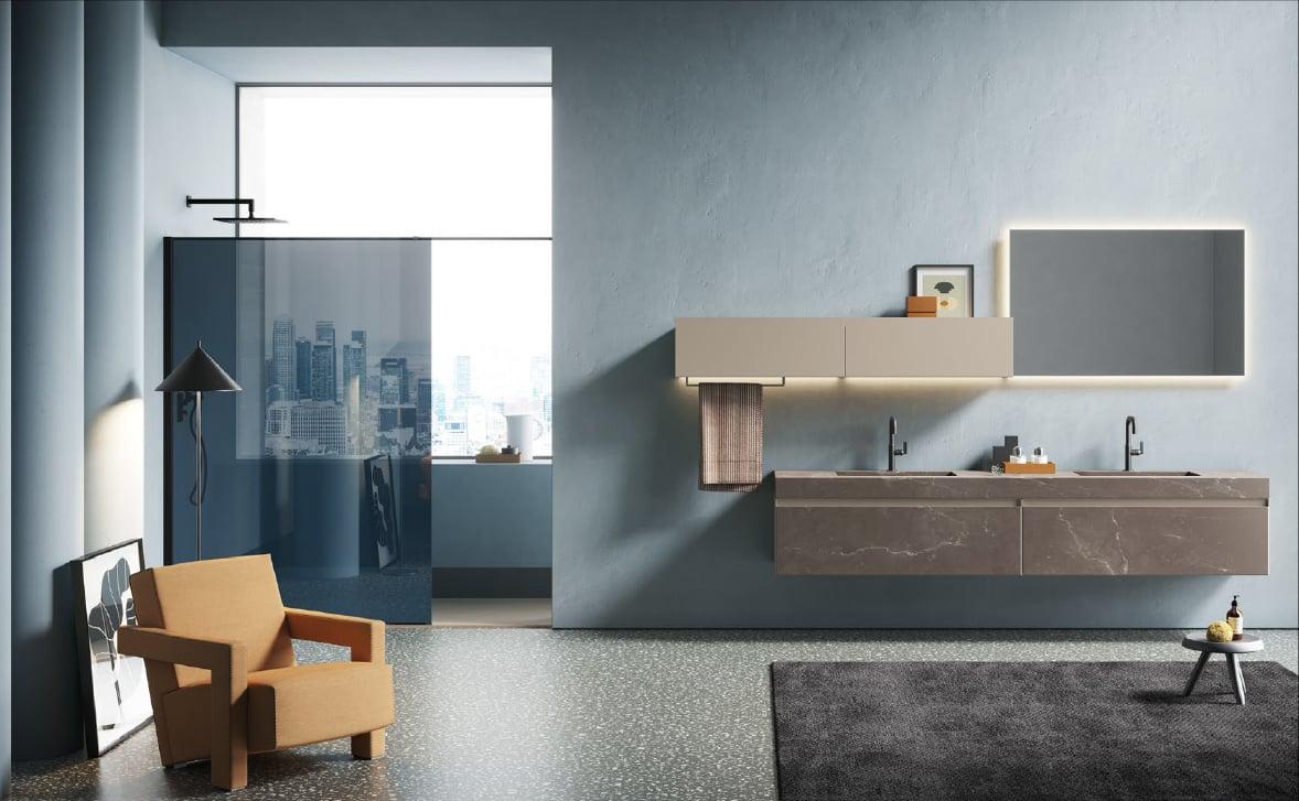 Bathroom with a floating double vanity and a glass shower, a tan armchair beside it