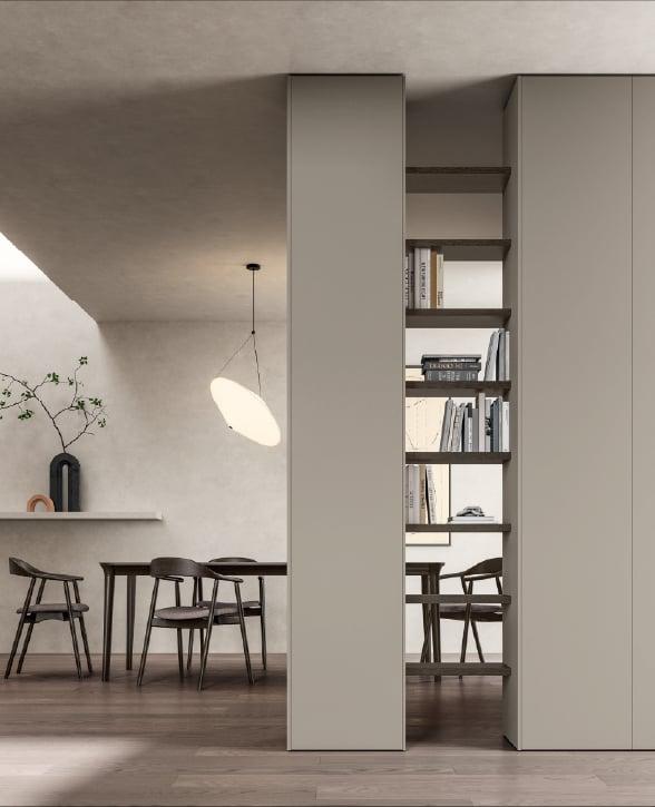 Tall pale column and open shelving dividing a dining area