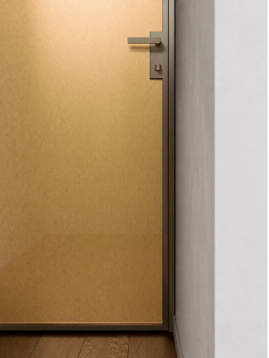Brushed gold door with a chrome handle